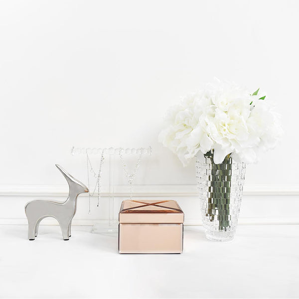Decor sculpture and rose gold Lucie square trinket box on console table.