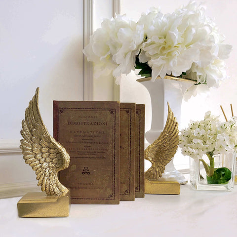 Petite gold feather wings bookends.