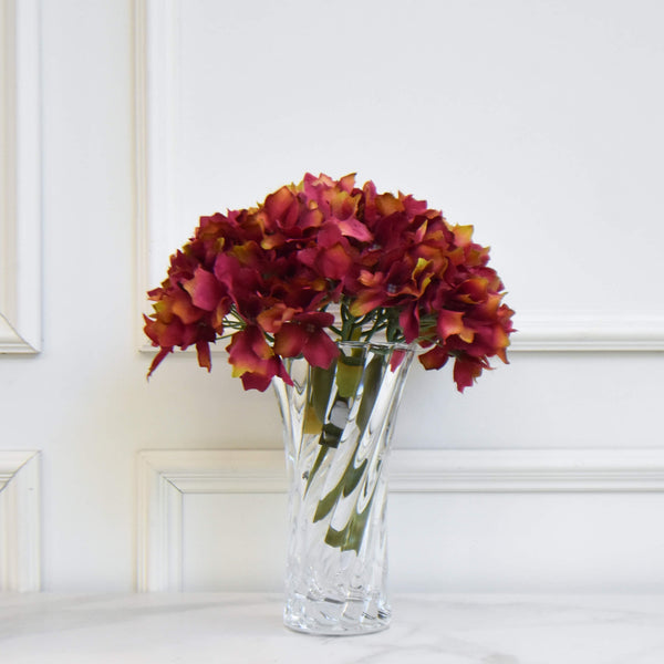 Small hourglass vase for a vintage feminine flair, add some hydrangeas for a fresh look.