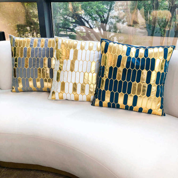 Gabbana Geometric cushions with gold details.