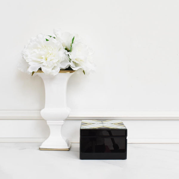 Side view of trinket box in mirrored black, gold, clear.