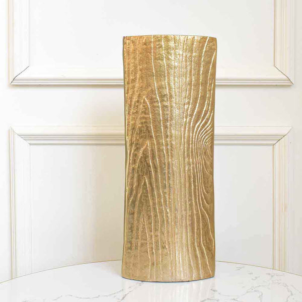 Made with aluminum, the Georg vase flaunts a matte gold earthy vibe with dimension of space for a modern home design. 