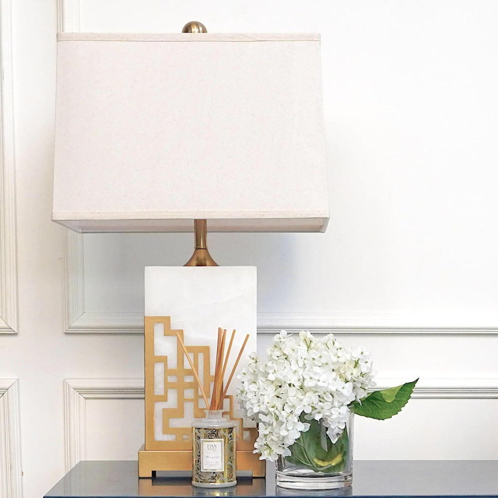 White and gold marble table lamp on blue gold console table decor 