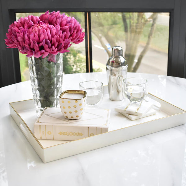 Stack small Candle votives to create a lux look on the dining table, keep things neat by placing them in a tray. 