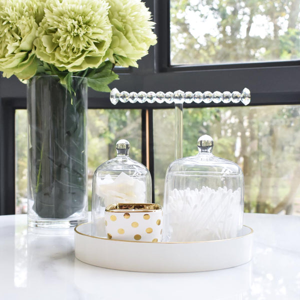 Peony flower arrangement on dining table in cylinder vase.