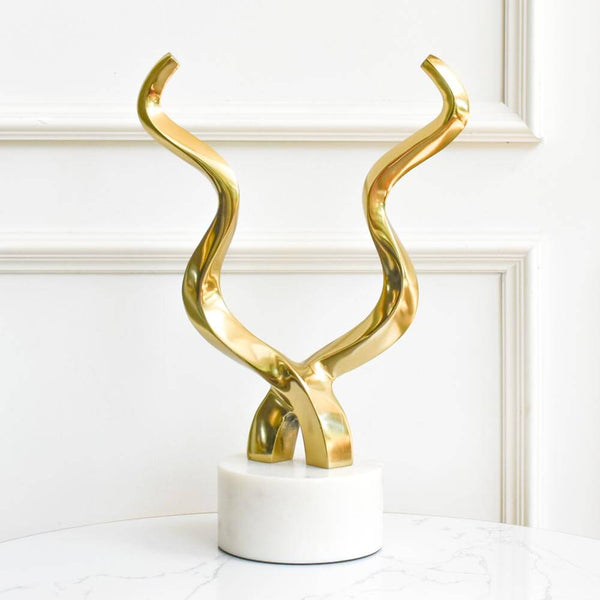Hunter gold horn in polished gold with white marble base.