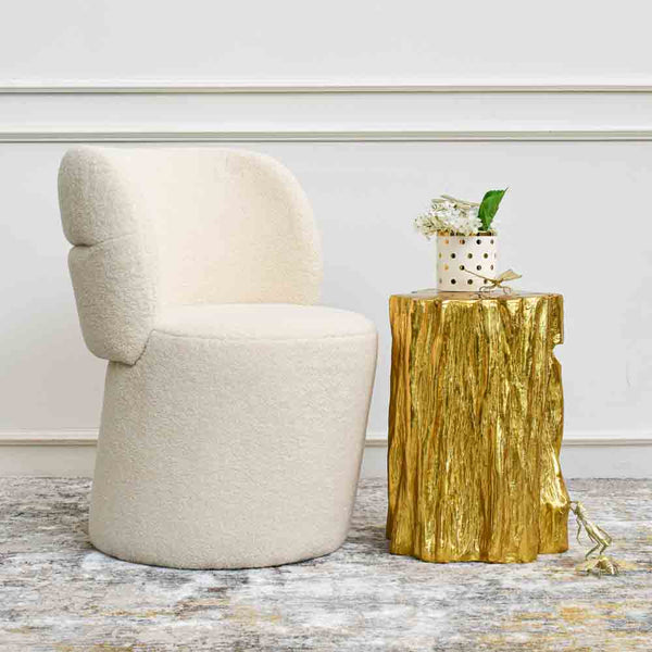 Gold insect cricket sculpture as a decor piece on Mercury tree stump side table.