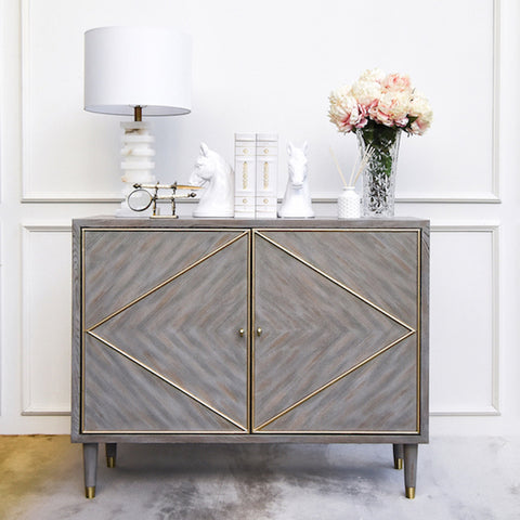 Linear wood design with gold-tone metallic accents add timelessness to your home design, while its elevated triangular design introduces a striking complement in any living room or bedroom room space.