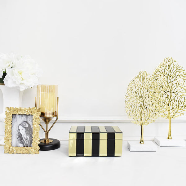 Black and gold trinket box for a bold contrast against an all white table.