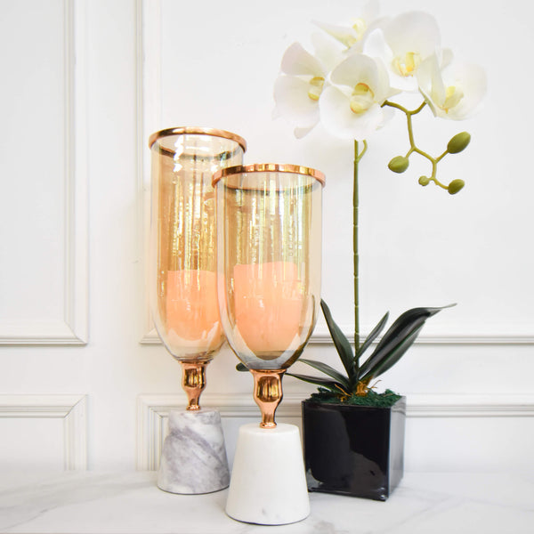 Fits Votive candles perfectly well in the tea tinted glass, Natural White Marble pedestal at the base for a classy look.