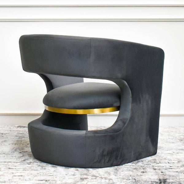 Back view of the Leedon armchair, sleek curves and stainless steel brushed gold underneath seat.