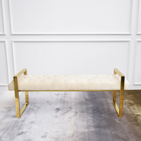 This luxurious modern bench takes your living room scene up a notch. It features an open, clean-lined gold frame and plush, velvet cream tufted cushioned seats. We love its glossy gold legs and plush cream velvet mingle.