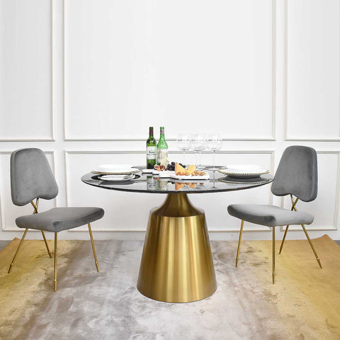 Round dining table pairs a sturdy, brushed stainless steel base with a round faux Black Marquina marble top.