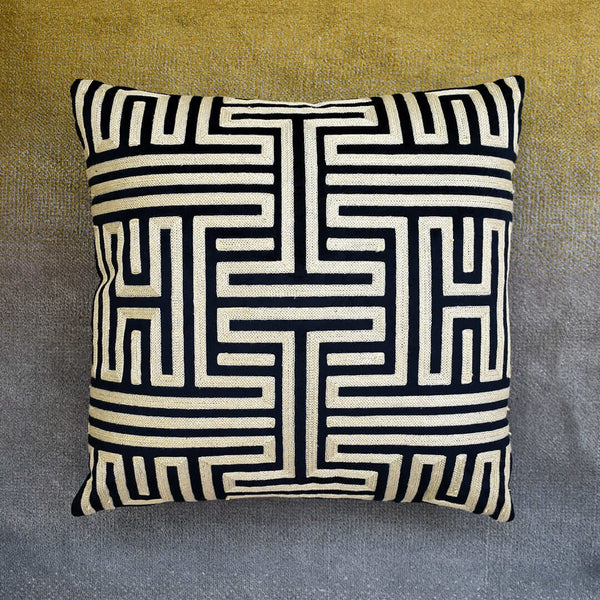 Black and gold Muse cushion against the Evka rug.