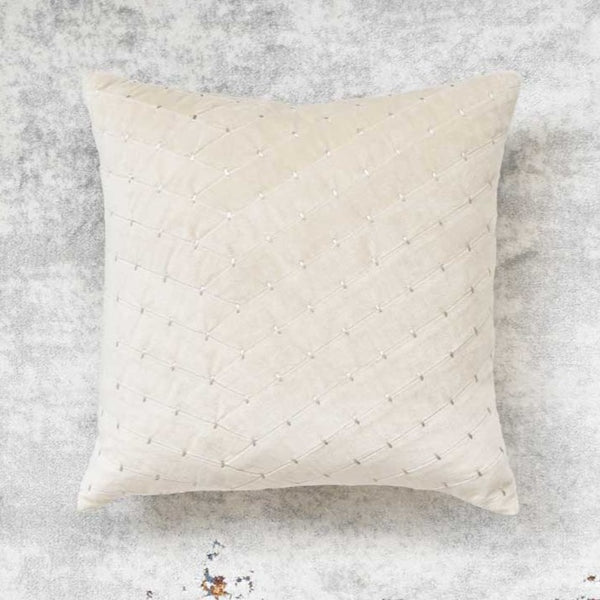 Paige stitched cushion throw pillow on rug, neutral velvet taupe. 