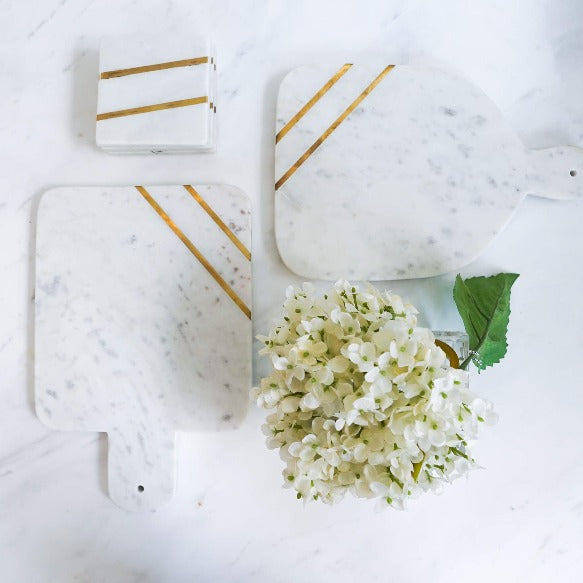 Waldorf's timeless marble gold trays cheese boards food platters coasters collection.