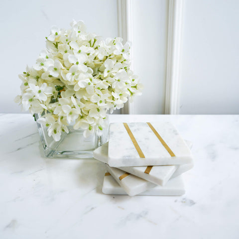 Park Avenue White Marble Coasters, Brass Inlay, Square on coffee table decor with flower and vase.