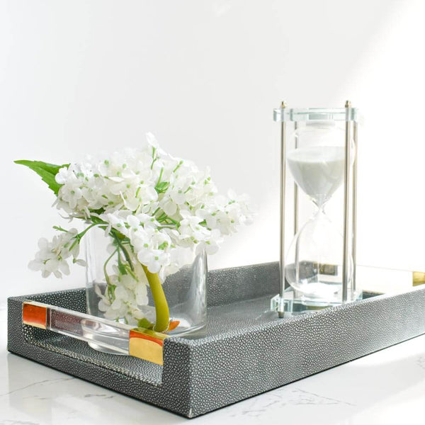 Clear acrylic base and white sand inside hourglass.