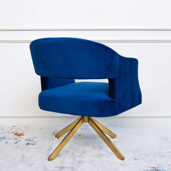 Side angle of the plush royal blue upholstery, create your own modern and glamorous living room space with the Tourner armchair.