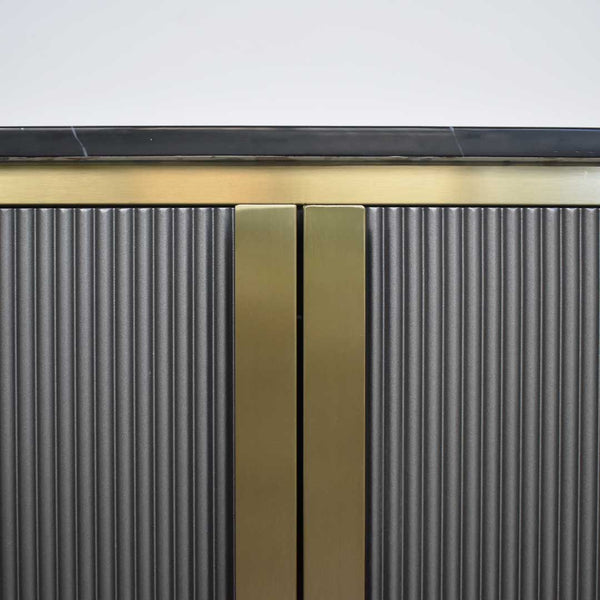 Hand painted Grey, the Verity cabinet contrasts with the gold steel details.