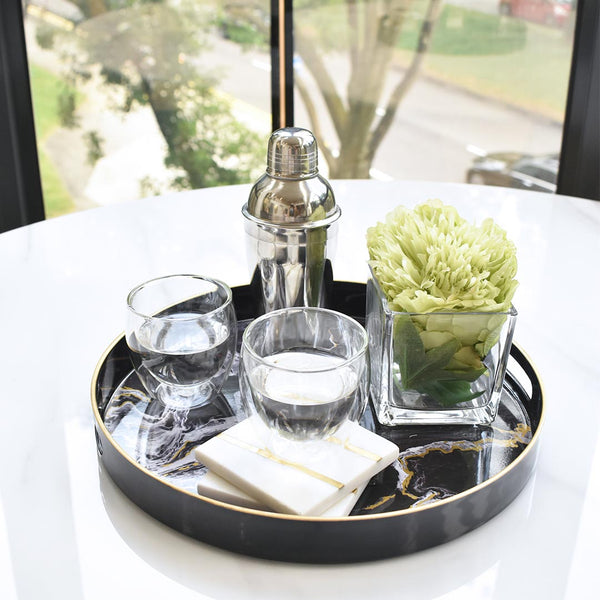 Lime green peony in a square vase in a round Leto tray.